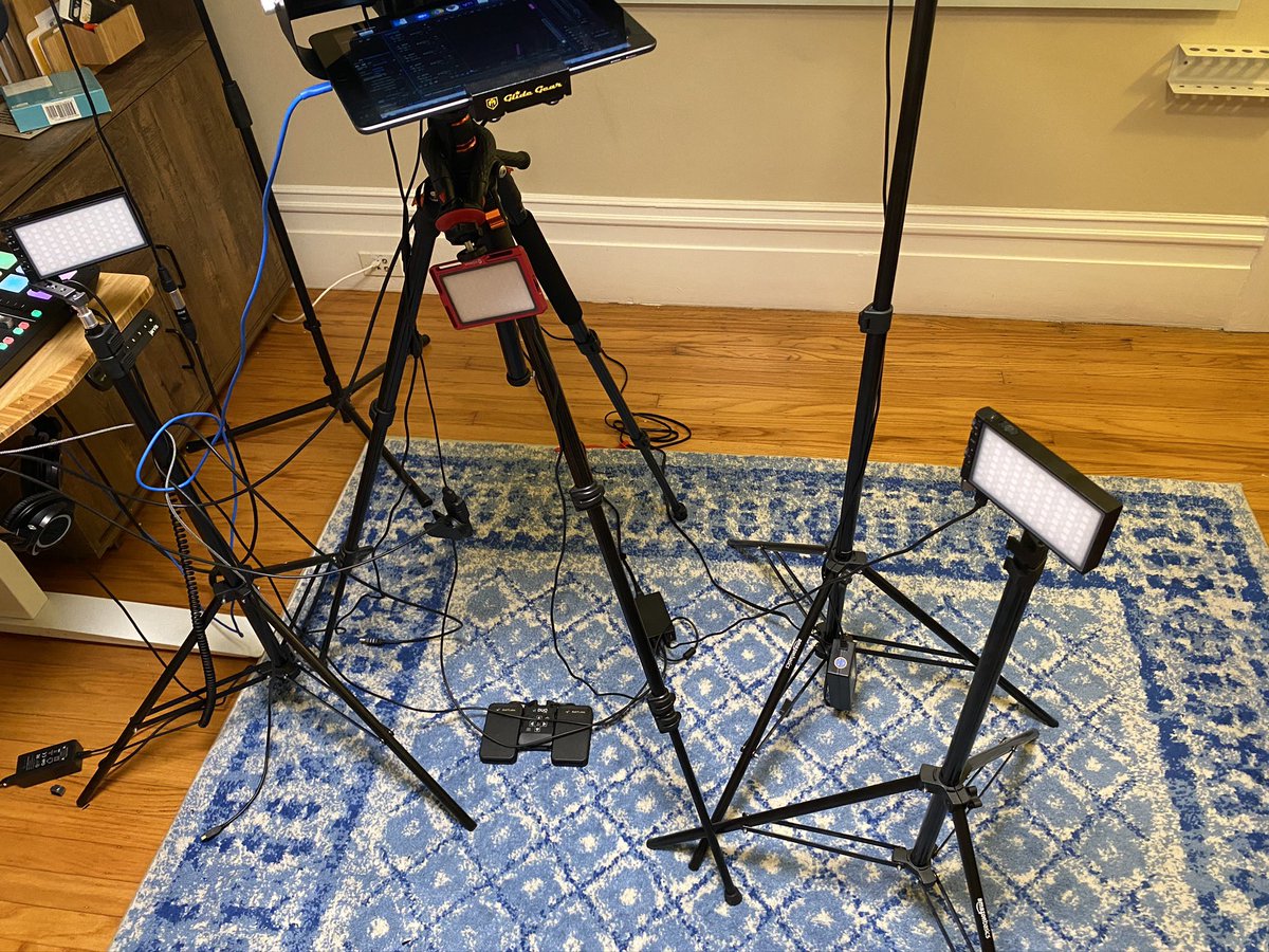 I also have two USB light panels on light stands. (A third older, crappy model is rarely used and clinging to the tripod). Under the tripod you can see my bluetooth foot pedal. That controls a number of teleprompter apps on the iPad for video work.