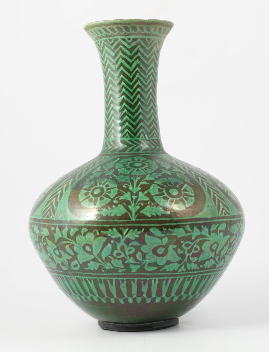 Object number 5 is an earthenware bottle with narrow neck and green glaze, made at the Bombay [Mumbai] School of Art in India.  #SouthAsianHeritageMonth