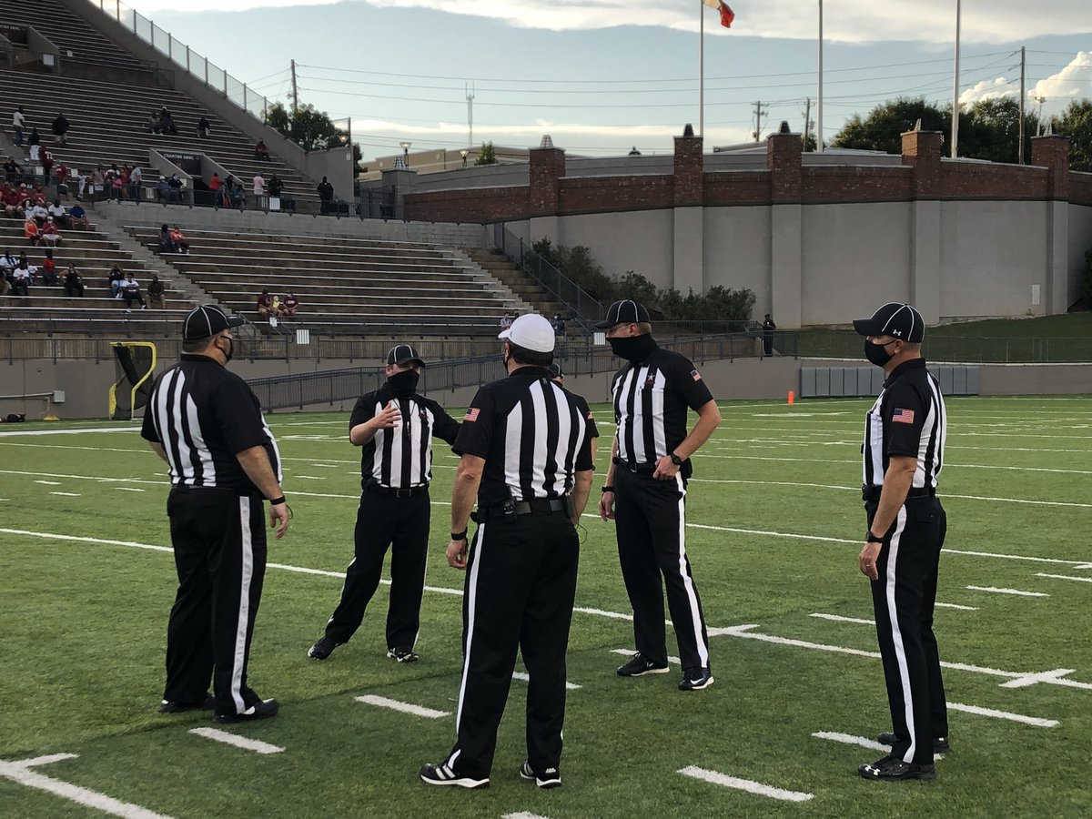 AHSAAUpdates's tweet image. Officials for tonight’s Kickoff Classic wearing their masks and staying socially distant before the game