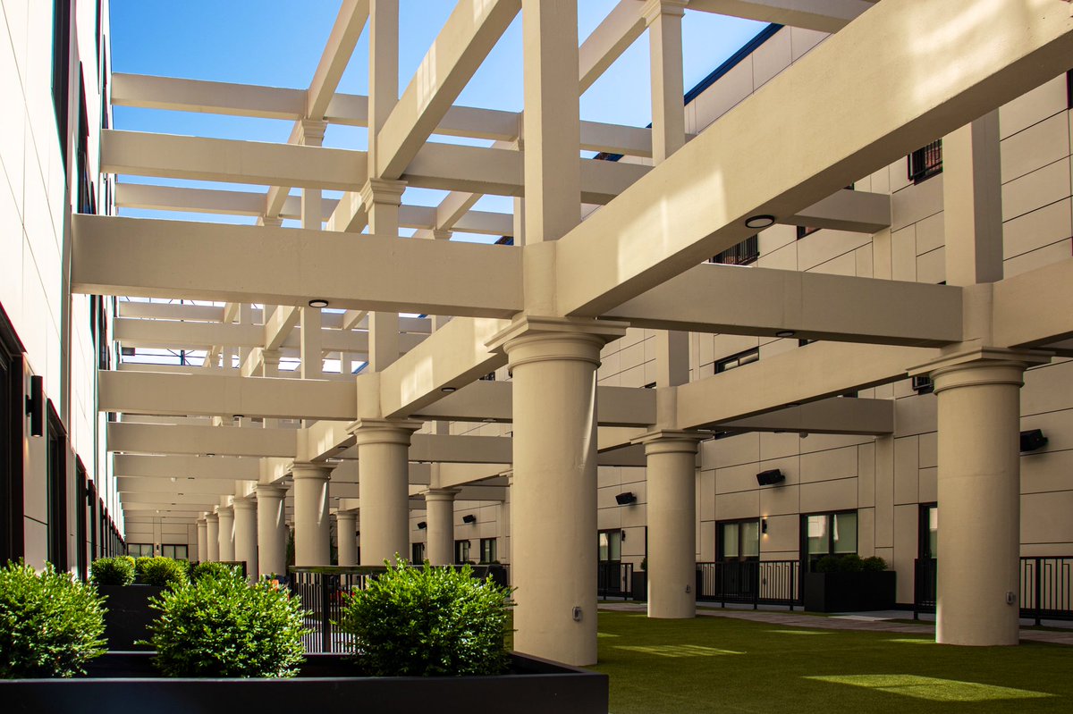 One of the most impressive features is the three-story, open-air atrium. The space was carved out of the center of the building, and the exposed structural elements + surrounding cityscape provide some unique, incredible views, and a serene escape for residents.