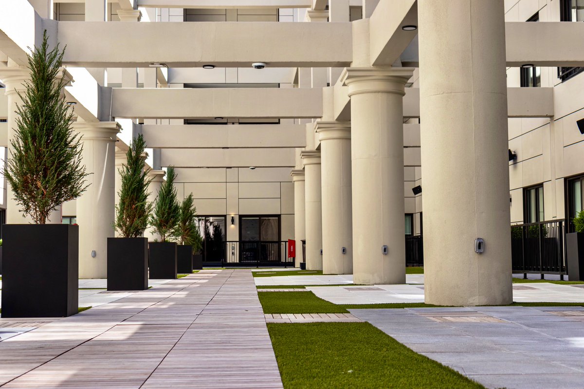 One of the most impressive features is the three-story, open-air atrium. The space was carved out of the center of the building, and the exposed structural elements + surrounding cityscape provide some unique, incredible views, and a serene escape for residents.