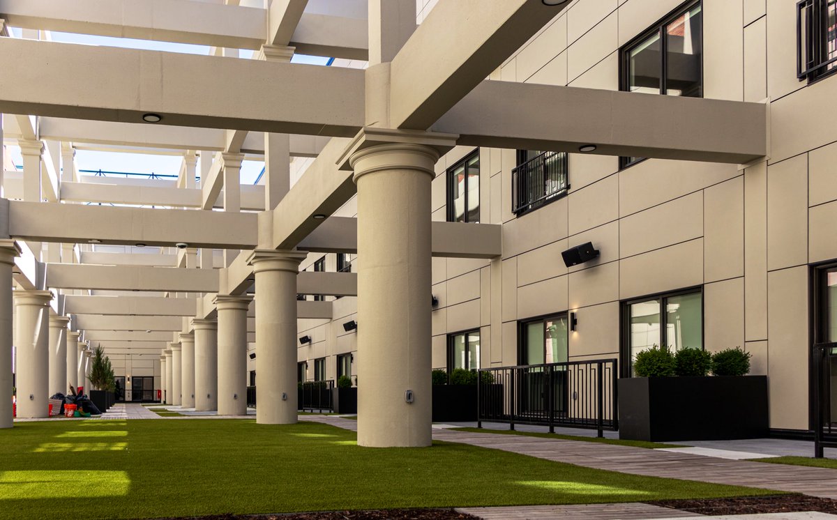 One of the most impressive features is the three-story, open-air atrium. The space was carved out of the center of the building, and the exposed structural elements + surrounding cityscape provide some unique, incredible views, and a serene escape for residents.