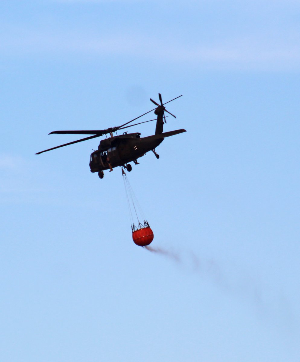 EditorSentinel's tweet photo. Today is National Aviation Day and aviators from 1st Air Cavalry Brigade are fighting fires with a Bambi Bucket. #ArmyAviation @forthood @1stCavalryDiv https://t.co/eBQtQ1GRgU