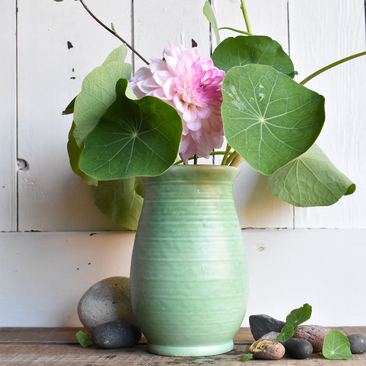 A Crown Ducal vase with an attractive fresh green mottled matt-finish glaze. Perfect for some hastily-snipped nasturtium leaves. Now in the online shop... #vintage #vintagehome #vintagegarden #vintagevase #crownducal #homegrownflowers #greenandpink #nasturtium #dahlia