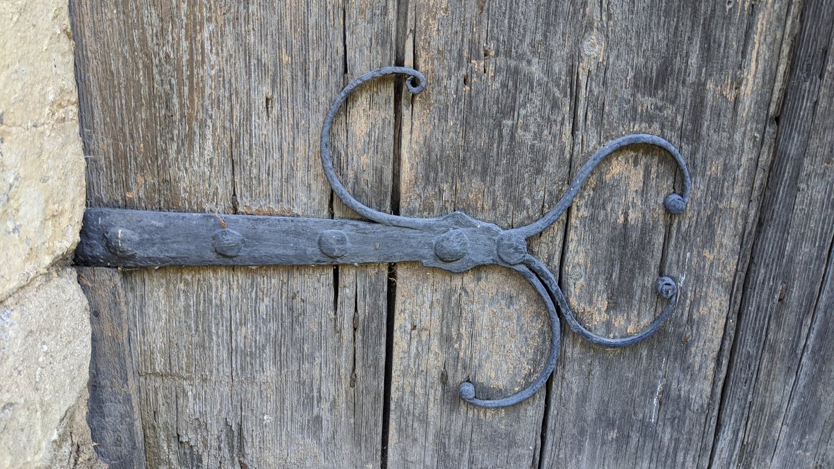 Heading back outside, I stopped to admire the door (and the graffiti) - the wood of the door is new(ish) but the hinges are the original ironwork from the 1200's.