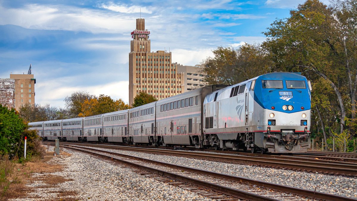 NOLA Bound - The @amtrak southbound City of New Orleans departs Jackson, MS while the Standard Life Building and King Edward Hotel observes its daily departure from the City With Soul. @narprail @KelbyOne @CanonUSAimaging @TrainsMagazine #amtrak #passengerrail #railroad