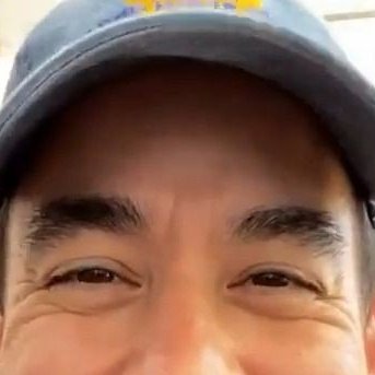 He smiles and closes his eyes, it's cute as fuck! 