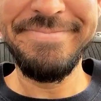 He smiles and closes his eyes, it's cute as fuck! 