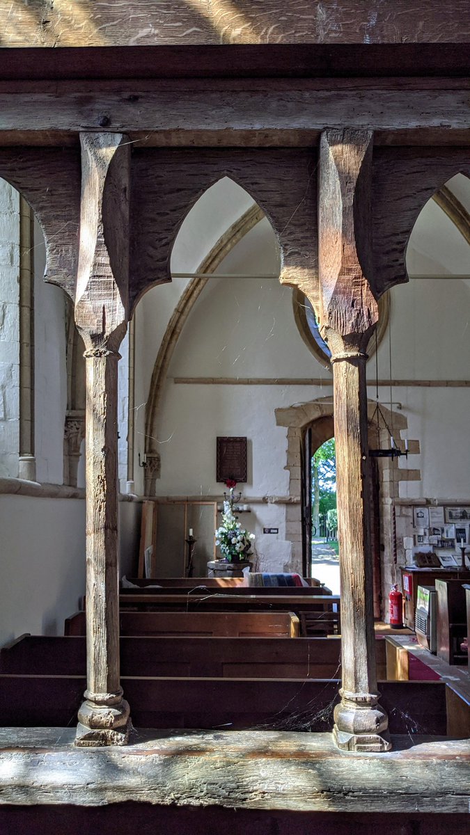 The wooden rood screen that spans the church is unique. The top and bottom sections, in darker wood, date from the 1900's - but the arcading, carved from lighter duller wood, is original to the church, and dates from the 1200's - it's one of the oldest examples in existence.