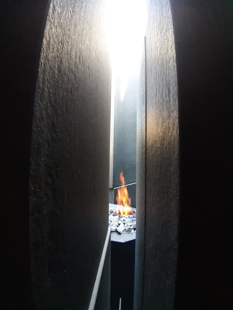 At the end of the ramp there is a cracked granite block symbolizing today's Hungary and its current 7 neighbour countries, with an internal flame inside.