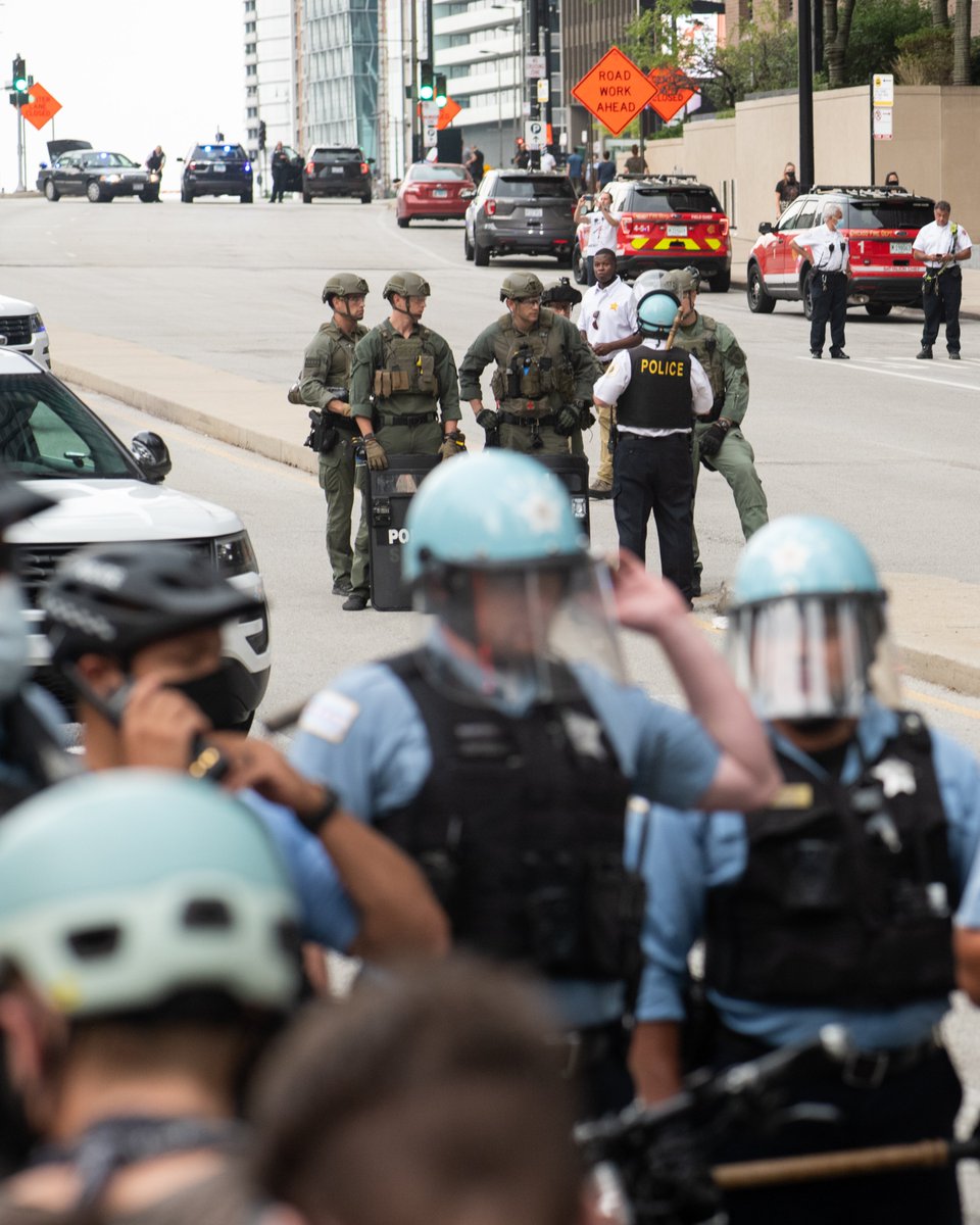 At this point a SWAT team arrived with heavy shields, pepper spray, and what I believe (?) is a tear gas unit (under the arm of the SWAT officer to the left).