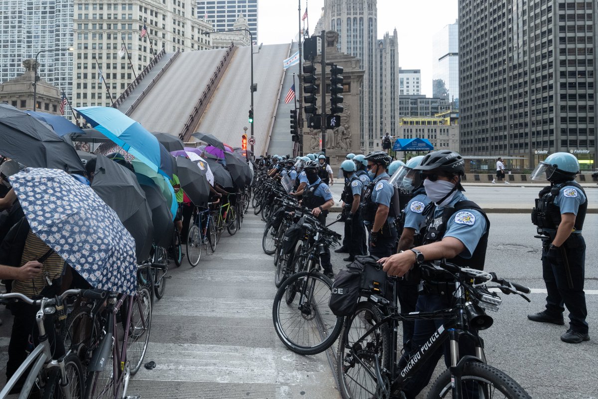 Protesters donned ponchos and goggles and asked for umbrellas to be brought to the bike line as protection from spray and gas. After a short time, police violently ripped the umbrellas away and then pushed into the crowd.