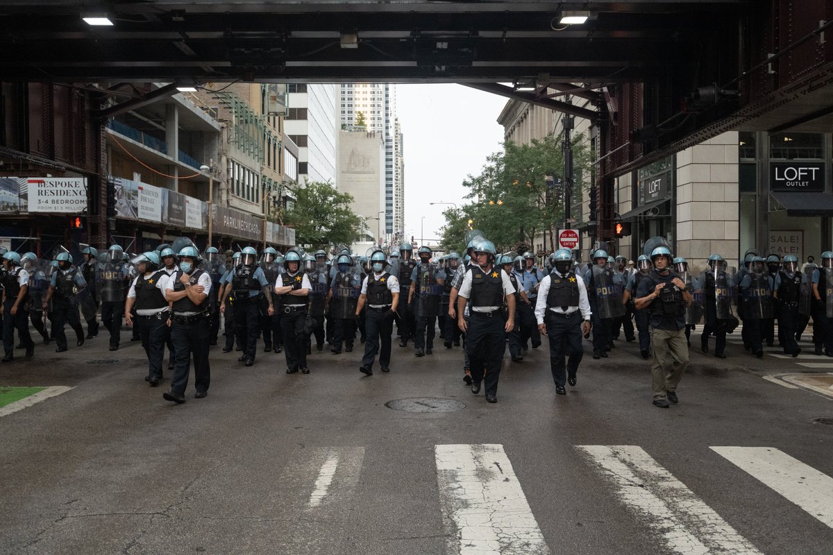After a pause at Michigan and Randolph, we headed west, followed by the cops. I started to feel claustrophobic, because bike cops were sent ahead on either side of the crowd, leaving only the path west. Raised bridges, and bike cops blocking streets in the distance.