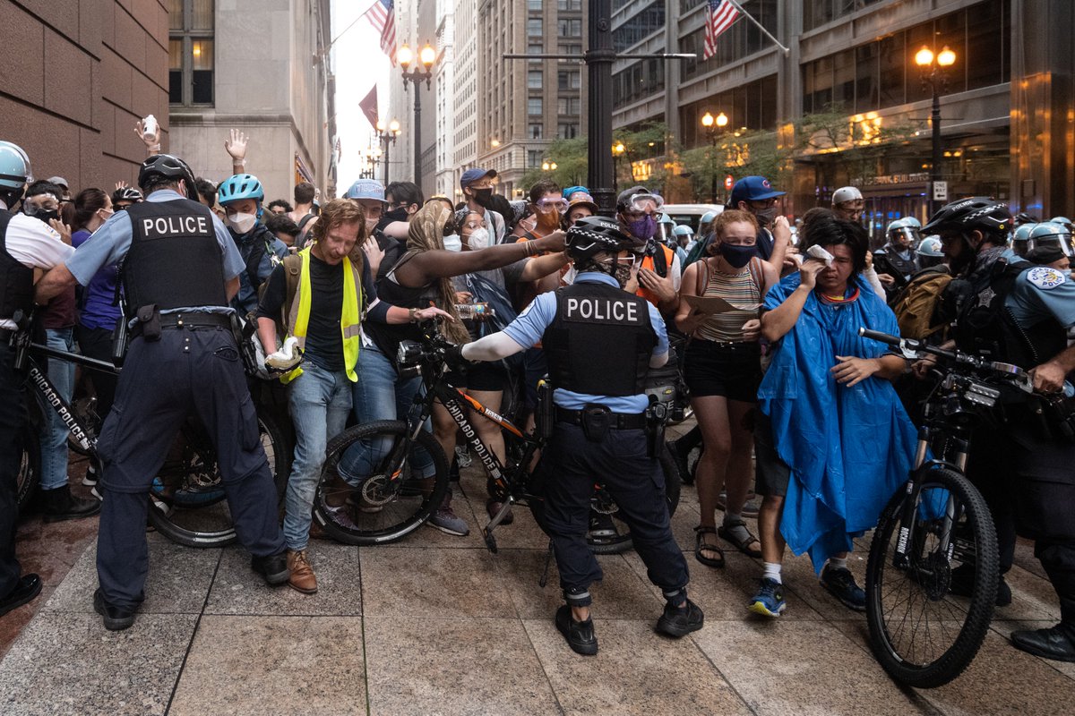Lines of police with bikes or shields held our group tightly on all sides against a building. This is called kettling. Some people were still incapacitated from the pepper spray.
