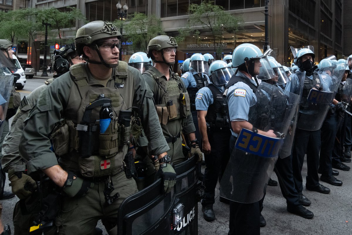 Lines of police with bikes or shields held our group tightly on all sides against a building. This is called kettling. Some people were still incapacitated from the pepper spray.