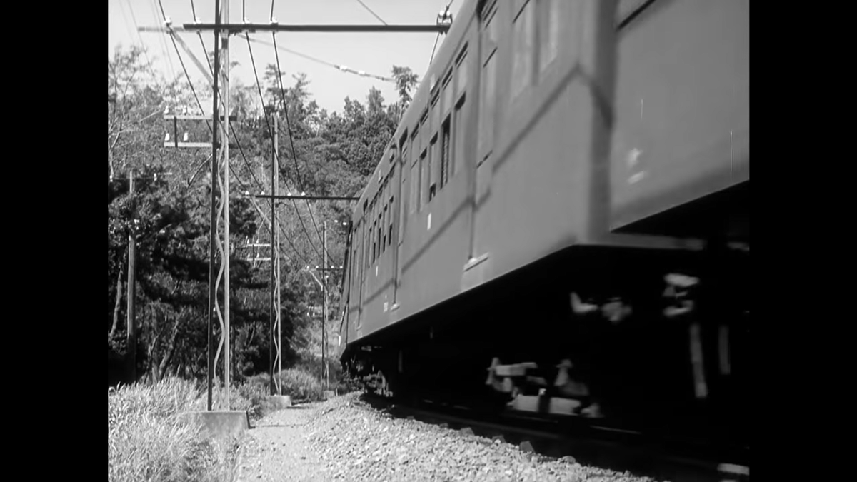 Our first actual train! Ozu spends a whole lot of time on this train ride. The dude loved trains, as we’ll see, and we actually get to see the whole train ride past in this shot.