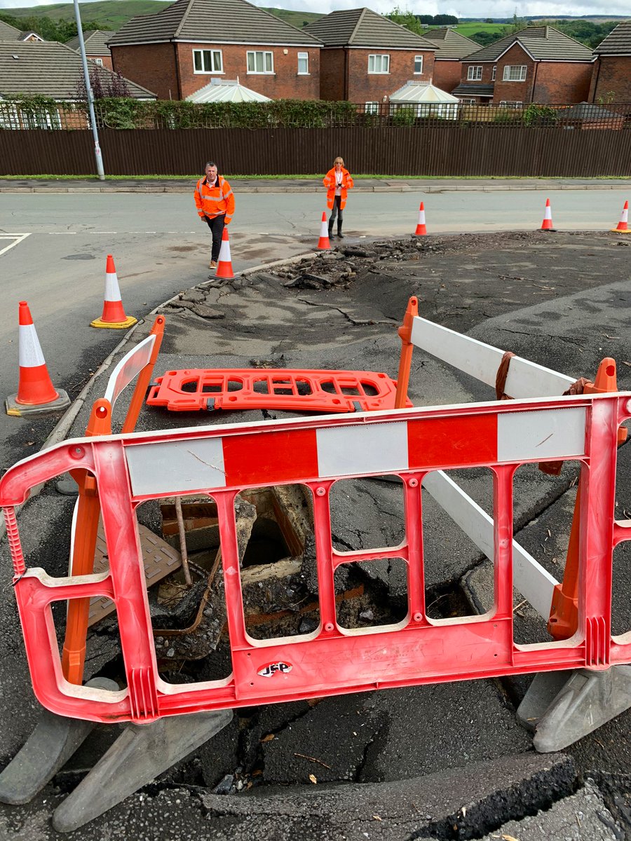 FoDDC_CEO's tweet photo. The power of the flow of water is clearly demonstrated by the damage to the footway alongside Gorof Road. Pleased to hear that the new drainage channel installed by @powyshighways and the swift work of local residents and @mawwfire saved more properties from flooding nearby. https://t.co/0QK6fbyljP