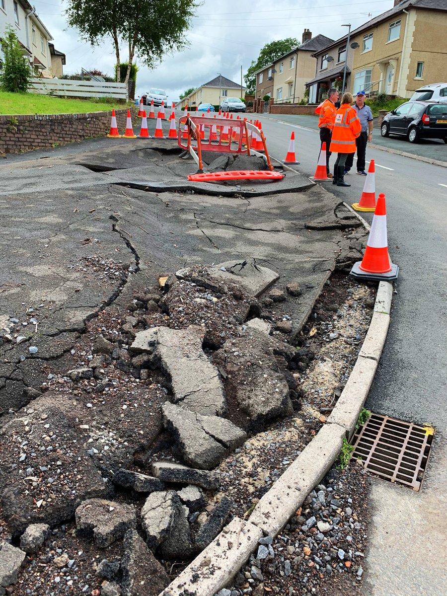 FoDDC_CEO's tweet photo. The power of the flow of water is clearly demonstrated by the damage to the footway alongside Gorof Road. Pleased to hear that the new drainage channel installed by @powyshighways and the swift work of local residents and @mawwfire saved more properties from flooding nearby. https://t.co/0QK6fbyljP
