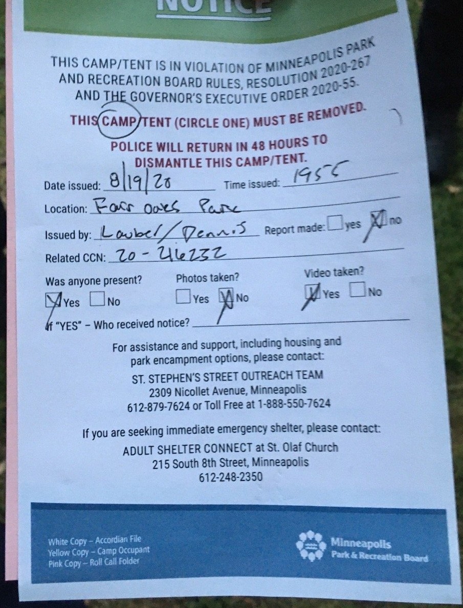 A notice dated 8/19/20 stating "This camp/tent is in violation of Minneapolis Park and Recreation Board Rules, Resolution 2020-267 and the governor's executive order 2020-55.  This camp/tent (circle one) [camp circled] must be removed.  Police will return in 48 hours to dismantle this camp/tent."