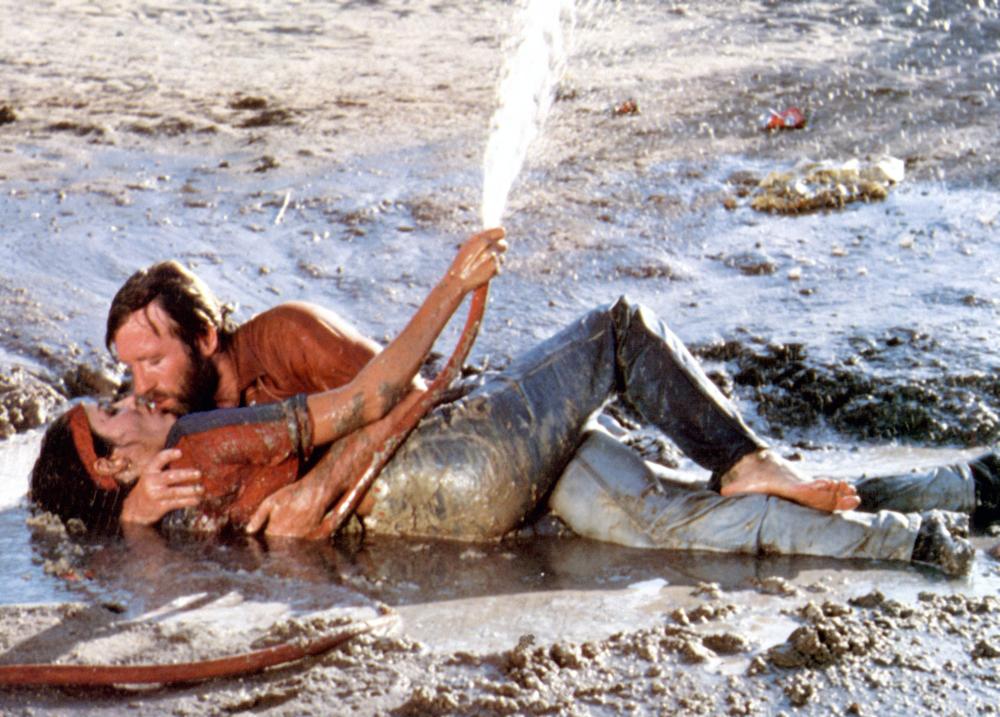 Oh yeah, there's also a love triangle happening. This scene is the movie's "From Here to Eternity" moment. McQuade and Lola frolic in mud and the garbage that McQuade had just thrown into his yard. There's also a broken toilet in the background. McQuade's idea of romance. /13/