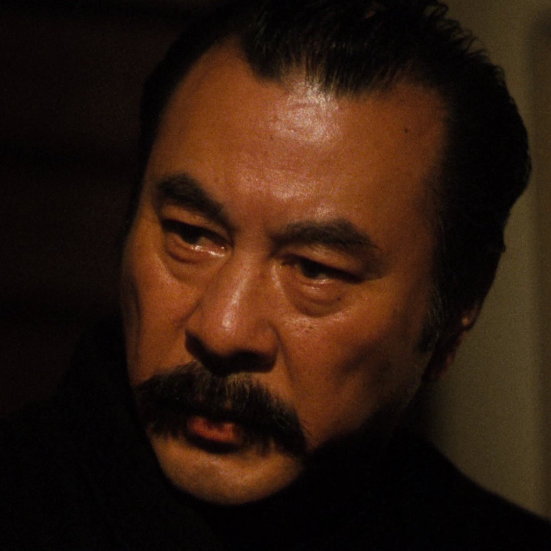 Antonio Inoki with a fake mustache as Tanaka. They're not all winners visually, but he fits the role.