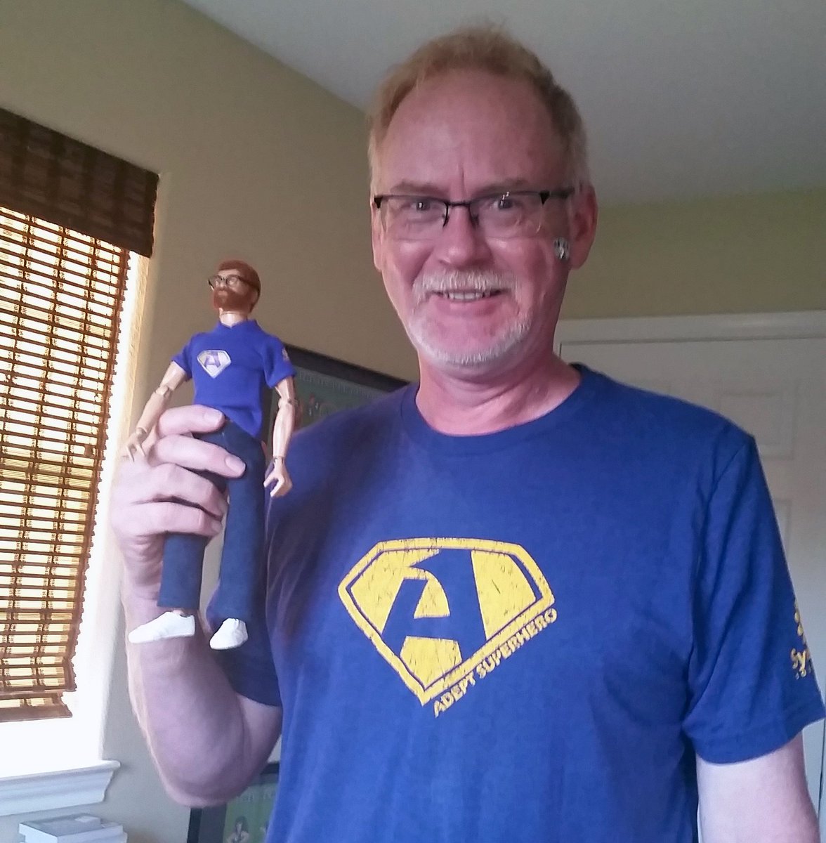 SynergisAdept's tweet photo. Check out this #FridaysFun shot of our happy client โtwinningโ with his lookalike action figure. Theyโre sporting our #Synergis #AdeptExperience 2019 classic superhero tee. https://t.co/m15VA6I8vp