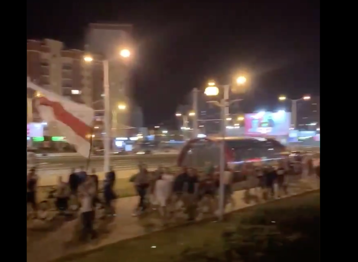 I am 90% sure this is the fascist flag of Belarus which the opposition is holding.