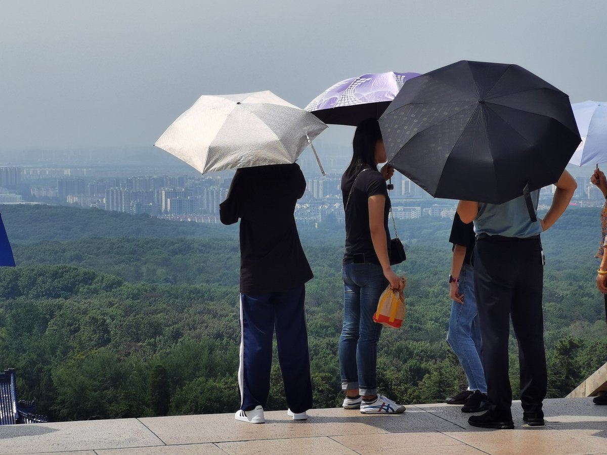32 — In summer, Chinese girls/ladies hold umbrellas or wear long sleeves not to tan — to stay cool but mostly not to tan.