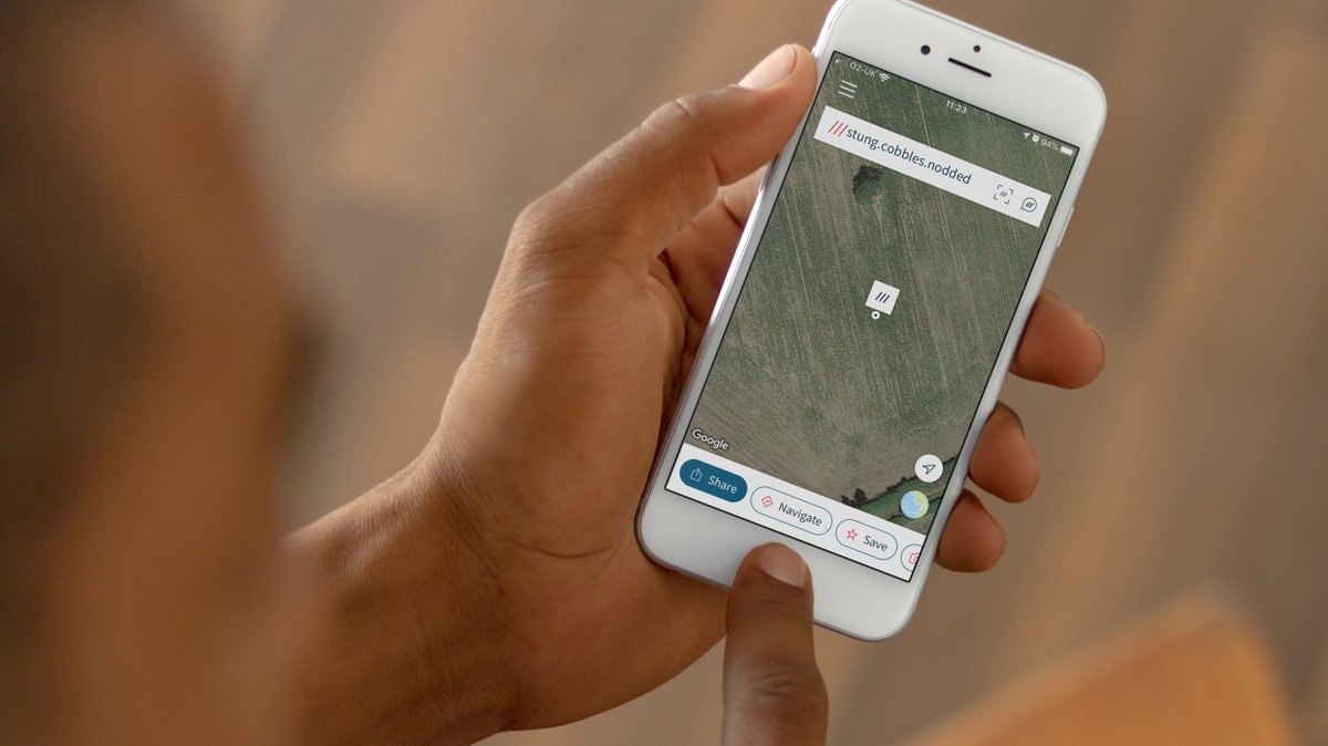 a hand holding a phone with the what3words app open