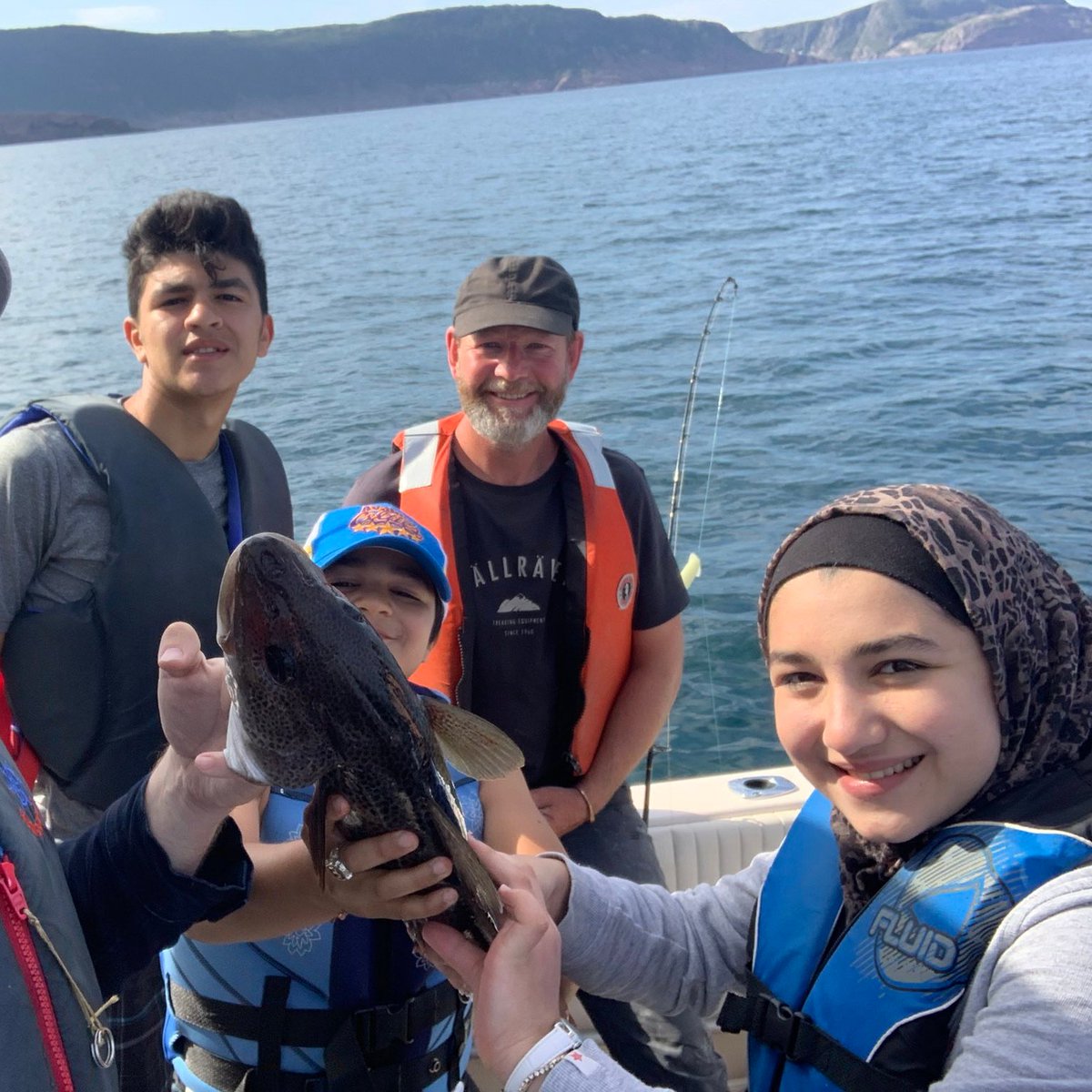MuhammadLila's tweet photo. Earlier this year, Canadians from all walks of life came together to help Yaman, an 8-year old Syrian refugee, fulfill his dream of playing hockey in Newfoundland.

At the time, a Canadian celebrity (@MarkCritch) offered to take them cod fishing.

Today, he lived up to his word. https://t.co/KEdgHfDclL