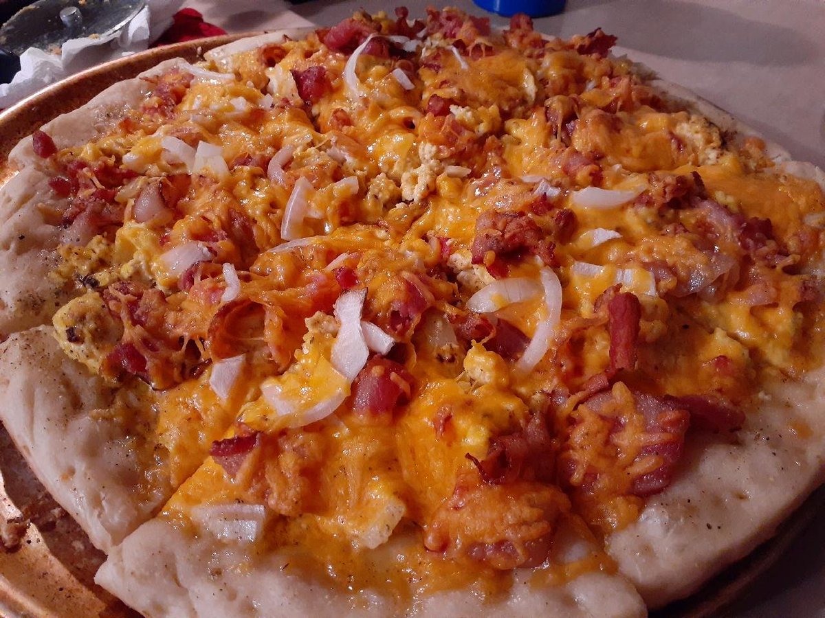Sunday Morning Breakfast Pizza: I call this the Bacon, Egg, Garlic, Onion, and Cheese Beast! Cooked and smoked on the Green Mountain Grill. 👨‍🍳♨️