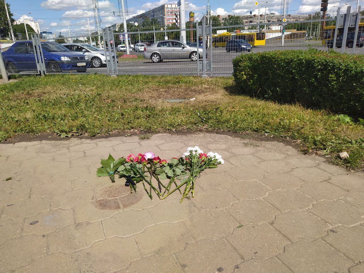 people in minsk bring flowers to the place where a protester died yesterday