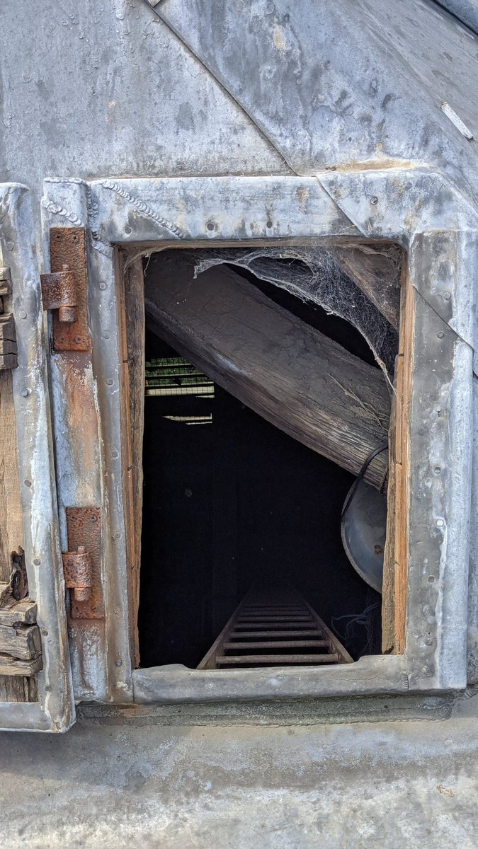 Finally, at the top of the ladder, I used my head and shoulders to push my way through the extraordinarily heavy lead trapdoor onto the roof. Hoping the extra weight and pressure wouldn't break the rusted rung of the ladder I was standing on.