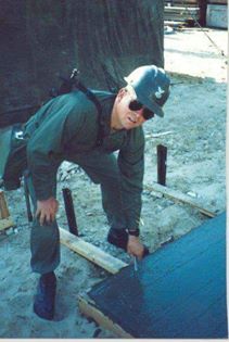 This wonderful Desert Shield memory was captioned & submitted by BU1 Rick Wilson!

BU1 Rick Wilson placing anchor bolt for Marine HQ latrine.

#Seabee#CanDo#DesertShield#Seabees