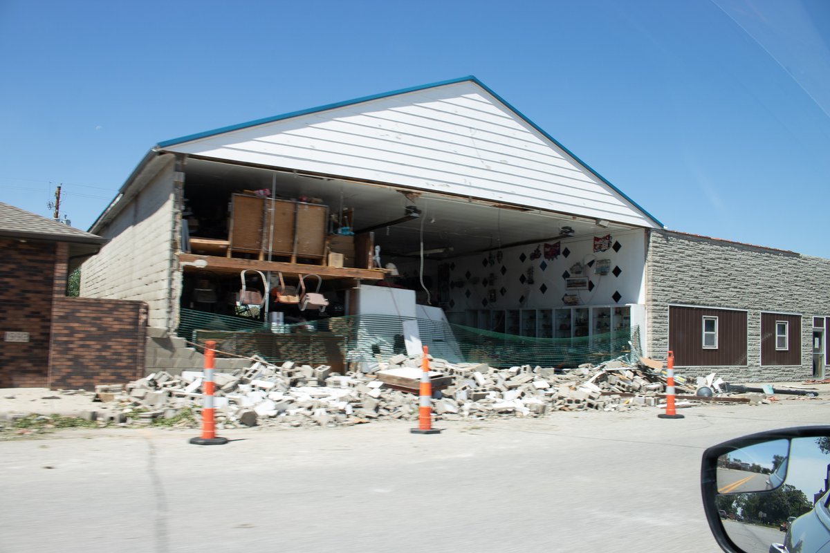 Woodward, IA had damage to some structures in town. One wall completely disintegrated due to garage doors being blown in and the pressure had nowhere to go, the wall then failed.