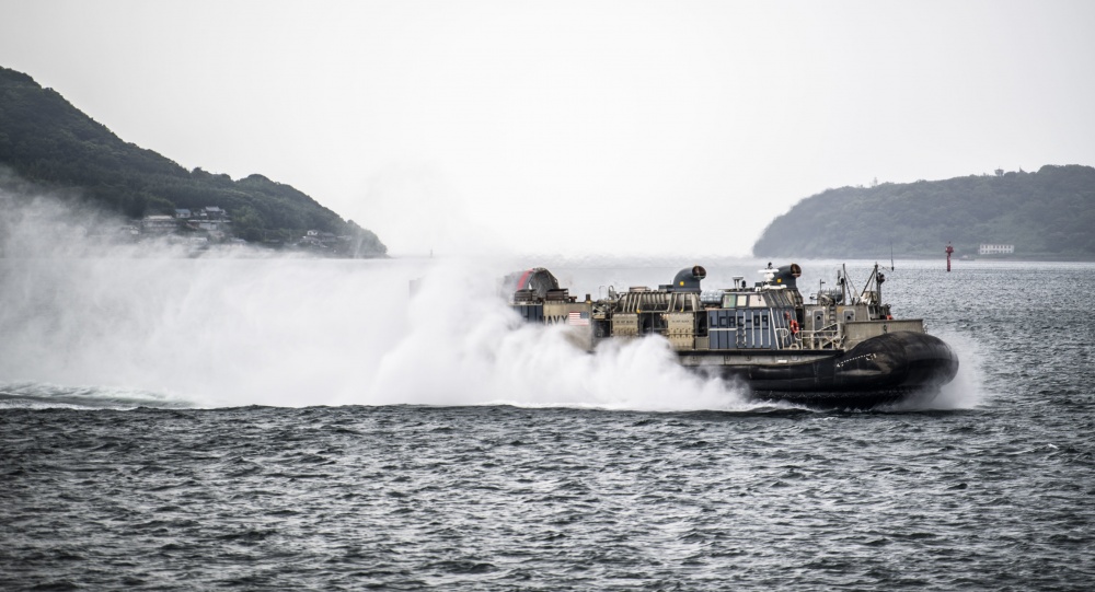 USPACOM's tweet photo. Sailors assigned to the @USPacificFleet amphibious dock landing ship USS Germantown #LSD42 conduct amphibious well deck operations with Landing Craft, Air Cushions #LCAC from Naval Beach Unit 7 #NBU7 off the shores of Sasebo, Japan. #ForgedByTheSea #FreeandOpenIndoPacific. https://t.co/ZE03yHZrWR