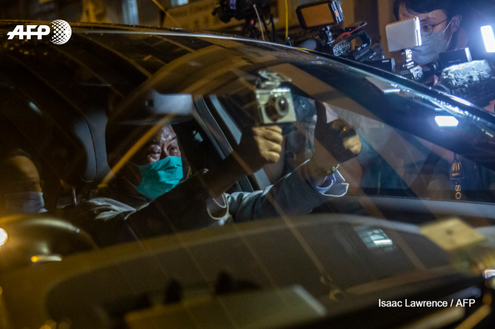 AFP's tweet photo. #UPDATES Hong Kong pro-democracy media mogul Jimmy Lai tells his reporters to "fight on" following his dramatic arrest, as China widens crackdown on critics in the semi-autonomous business hub https://t.co/fyB0k3MAZX https://t.co/QhGkwvs5K8