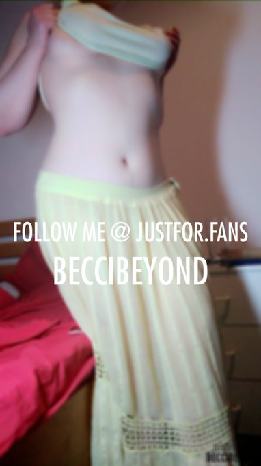 Bright lighting hits my stomach and breasts as I lift my top and turn to present my ass and pussy, of