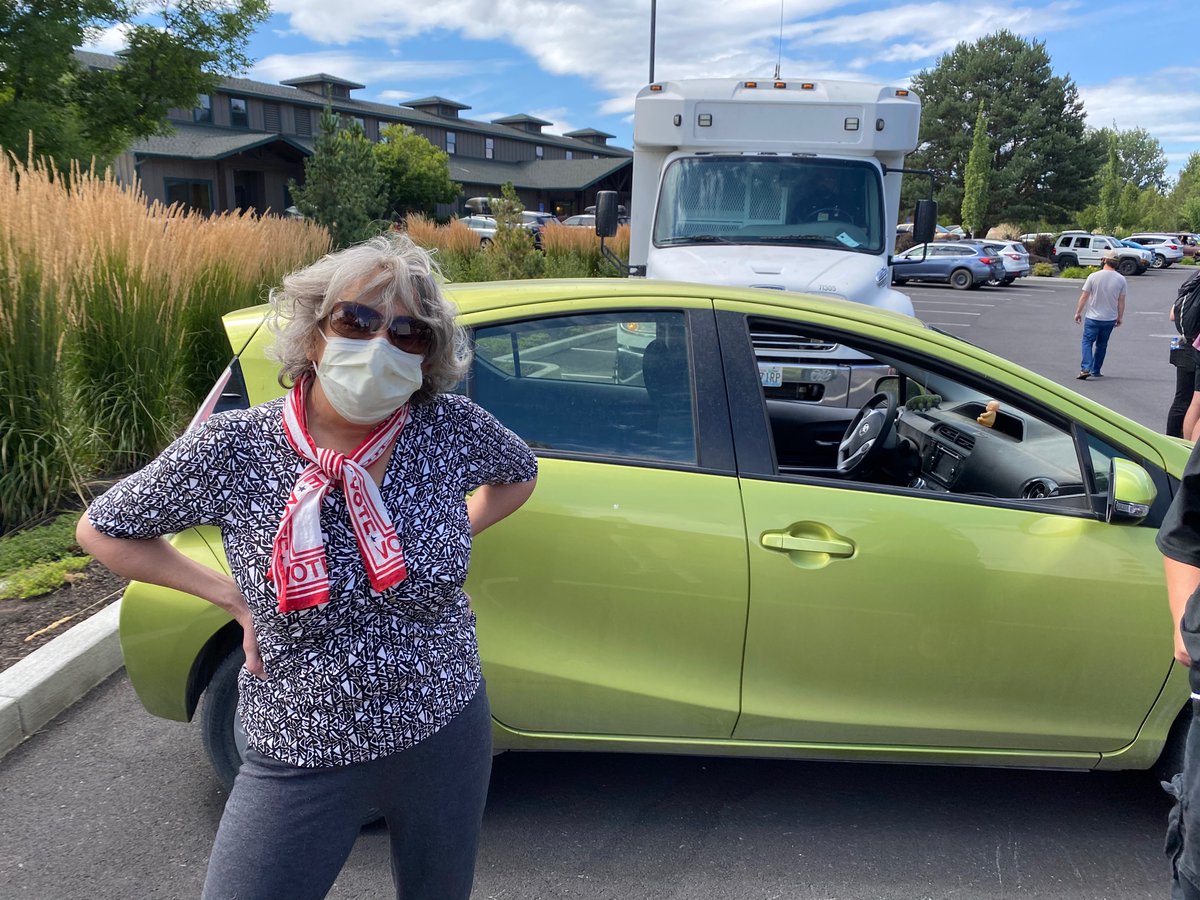 Outspoken Bend city councilor Barb Campbell just arrived, edging past protesters to park her hybrid directly i. front of the second bus. 'I thought this was a great spot'