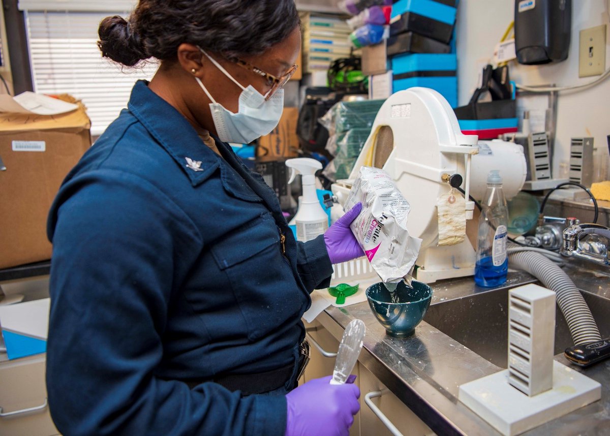 HM3 Ellysse Tilley, assigned to the dental department aboard the Nimitz-class aircraft carrier @GW_CVN73, pours alginate impression powder into a mixing bowl in order to create a maxillary essix retainer. (@USNavy photo by MC2 Trey Hutcheson)