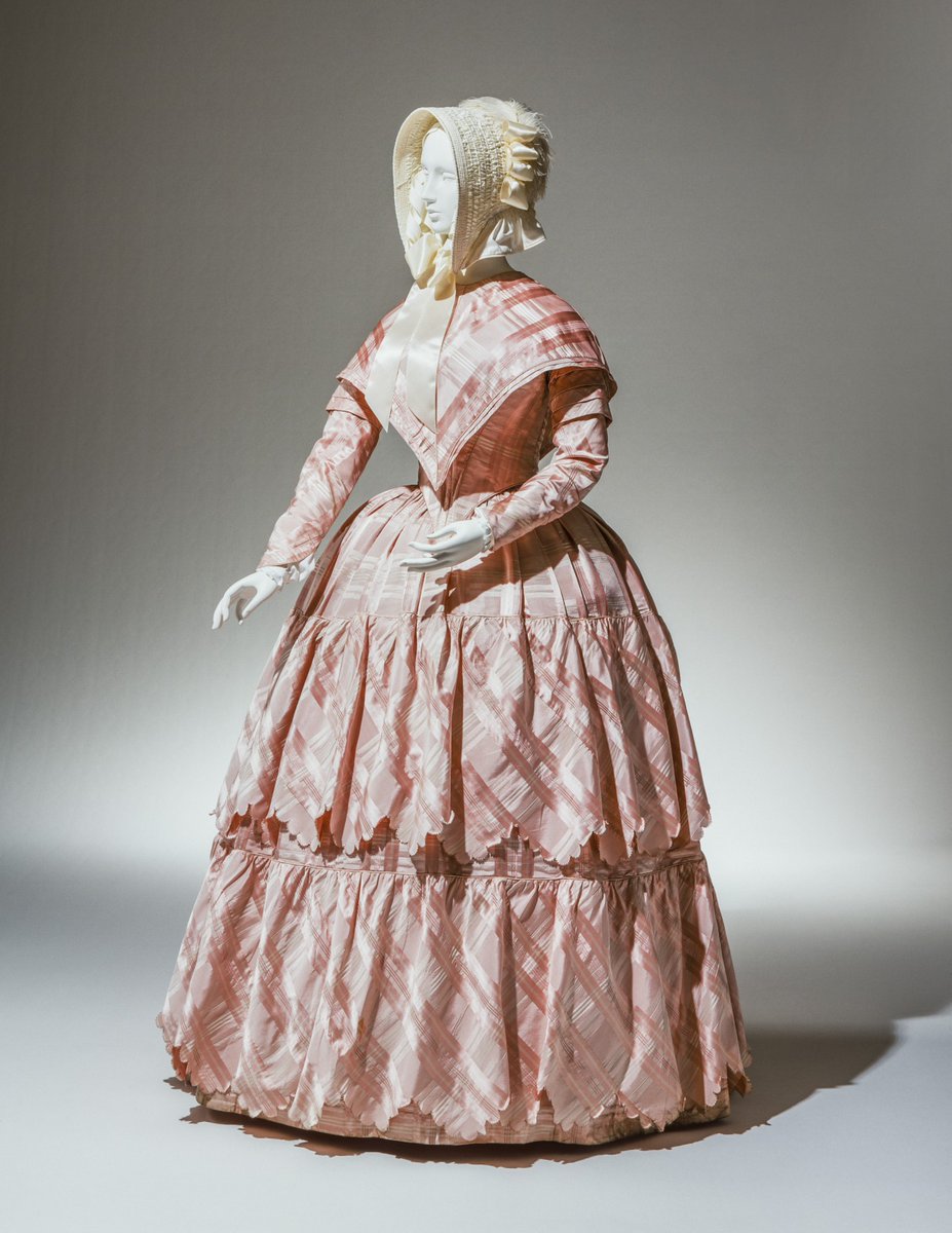 Compare to this woman's outerwear ensemble, from the Cincinnati Art Museum's collection. Dating to 1843-1845, it shows the pelerine, a cape of lace or silk that coordinated with the skirts and followed the lines of the bodice.