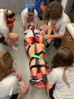 LBHSAT's tweet photo. LBHS Athletic Training Student Aides have been learning new skills this week! Yesterday, we learned how to spineboard an athlete with a suspected spine injury! They’ve all done a great job so far and we’re proud to have them as student aides! ♥️🐴 https://t.co/hLwy7B9RnL