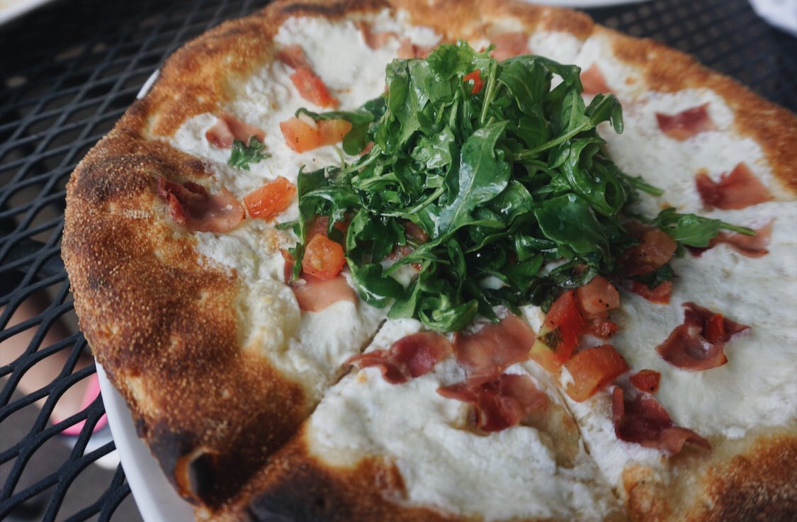 Fridays come faster w/ pizza, we don't make the rules. 😉 Pictured: our iconic Napa pizza topped w/ fresh arugula. Not pictured: the chilled glass of Acrobat Pinot Gris to pair with your 'za. 🙌