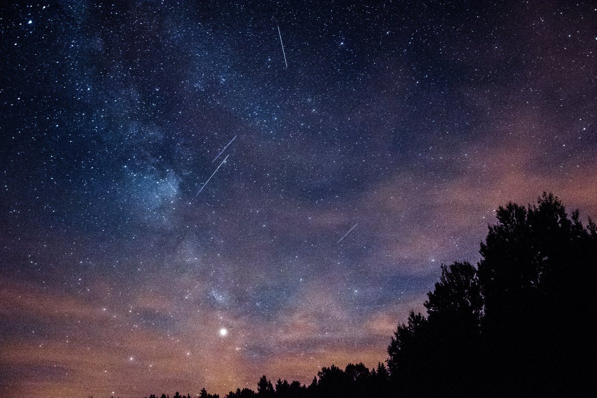 A clear night sky showing the Milky way and the Perseid Meteor shower