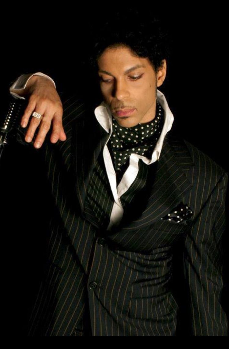 In a nod back to 2004’s Musicology era, Black Sweat sees Prince don a dangerously dapper black & grey pin-striped suit, silver liquid satin shirt, custom dove grey heels & trimmed homburg hat for the music video. Let’s take a moment to celebrate Prince in pinstripes.