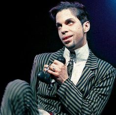 In a nod back to 2004’s Musicology era, Black Sweat sees Prince don a dangerously dapper black & grey pin-striped suit, silver liquid satin shirt, custom dove grey heels & trimmed homburg hat for the music video. Let’s take a moment to celebrate Prince in pinstripes.