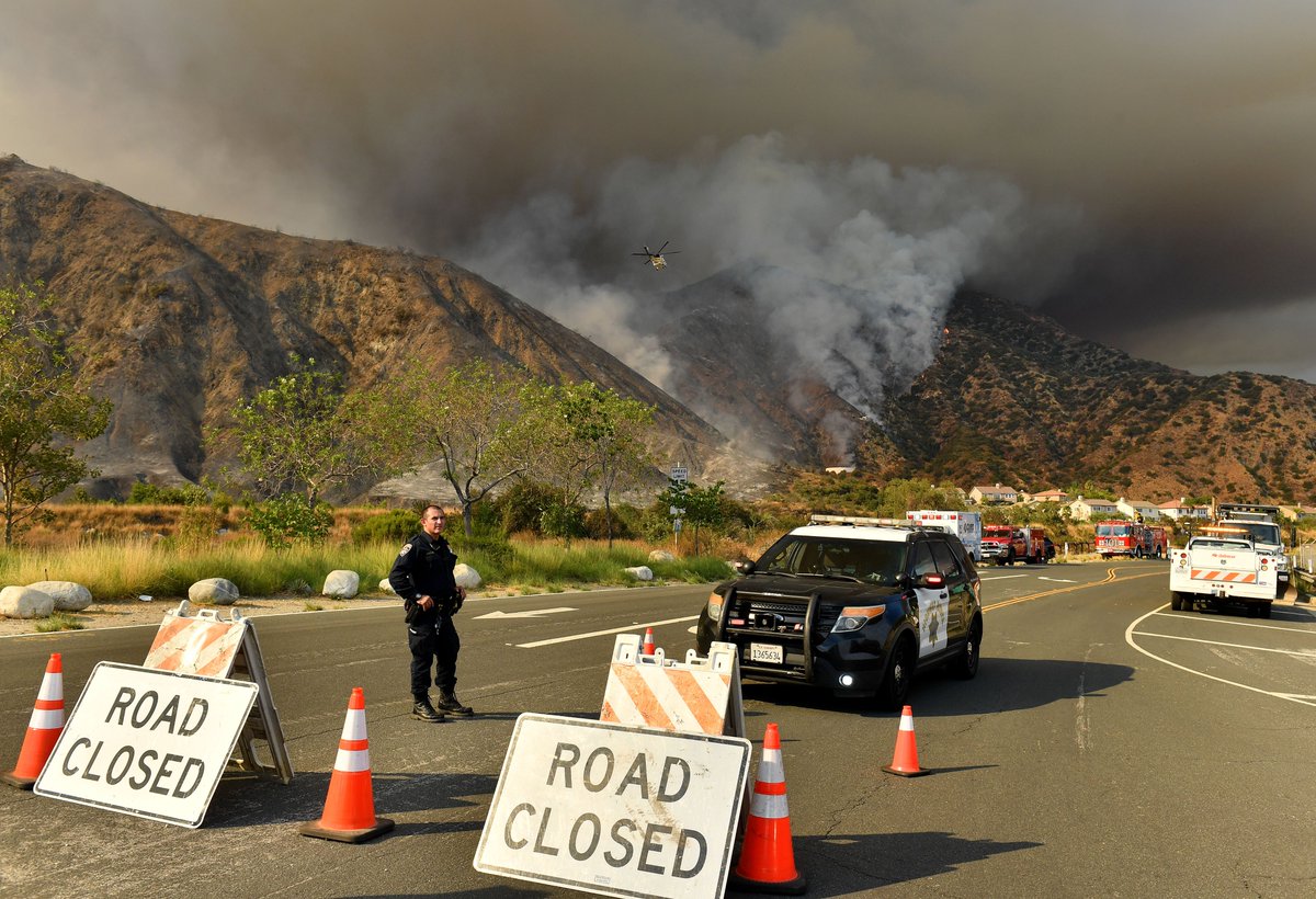 An aggressive air attack behind homes in #Azusa Canyon pushes flames away during the #RanchFire Thursday afternoon off of Hwy 39.