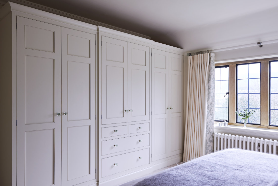 A restful master bedroom project. Classic 6-door, break fronted wardrobes, finished in #slippersatin from @farrowandball with crystal handles. Our wardrobes are bespoke, designed and made for the space available with internal storage options personalised to requirements.⁠
⁠
