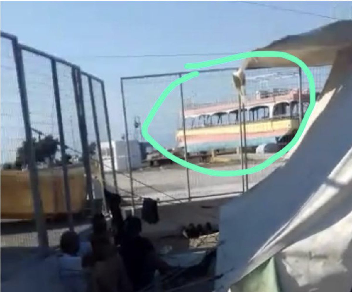 For a start, you can see this strange ship in the background, beyond the camp fence. The green circle is my annotation of a screengrab from the video.