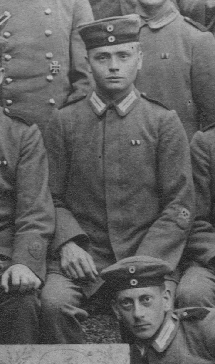 I started finding images of men who wore the badge ABOVE the cuff, right below the elbow.